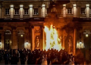 Fire is lit at the Bordeaux Town Hall during French pension demonstrations.